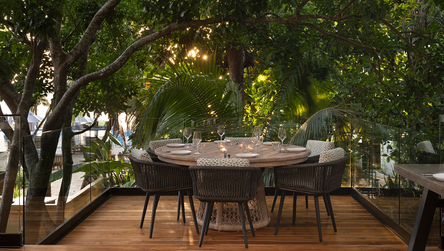 Large family table on patio at Alera surrounded by green trees