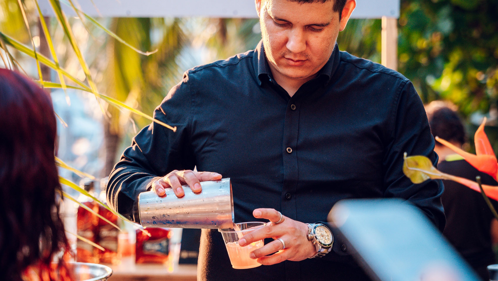 Serving pouring a cocktail at Grand Roatan Food & Wine Festival