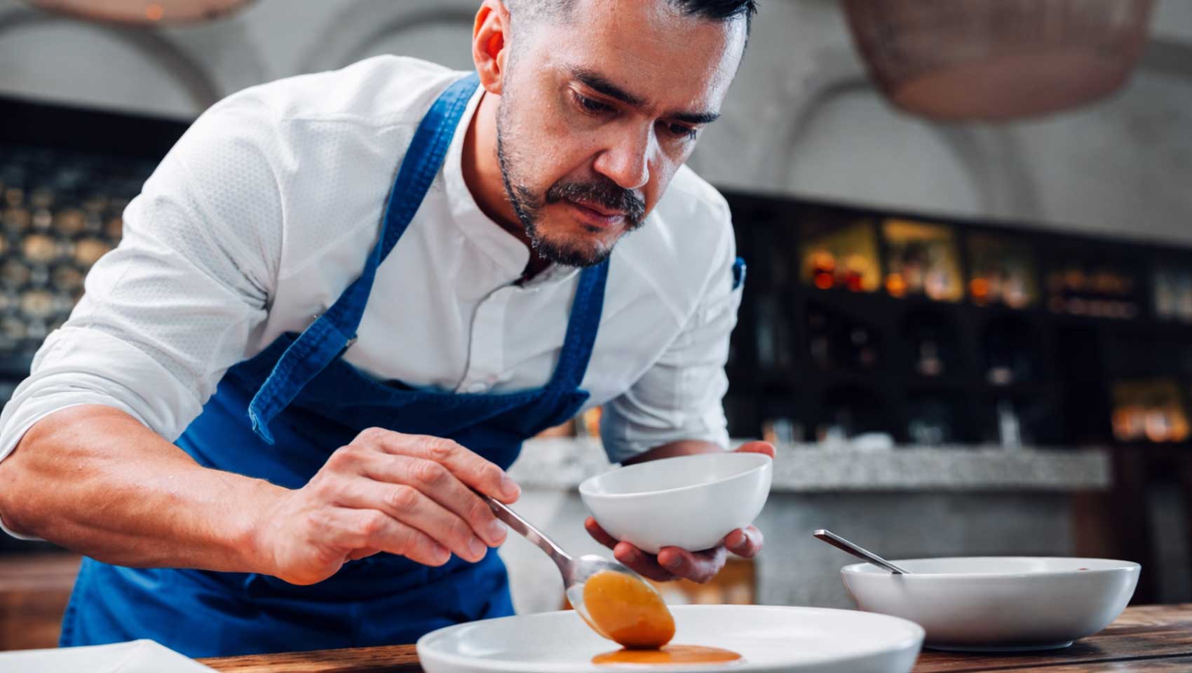 Chef Guido Ojeda plates a dish at Kimpton Grand Roatan