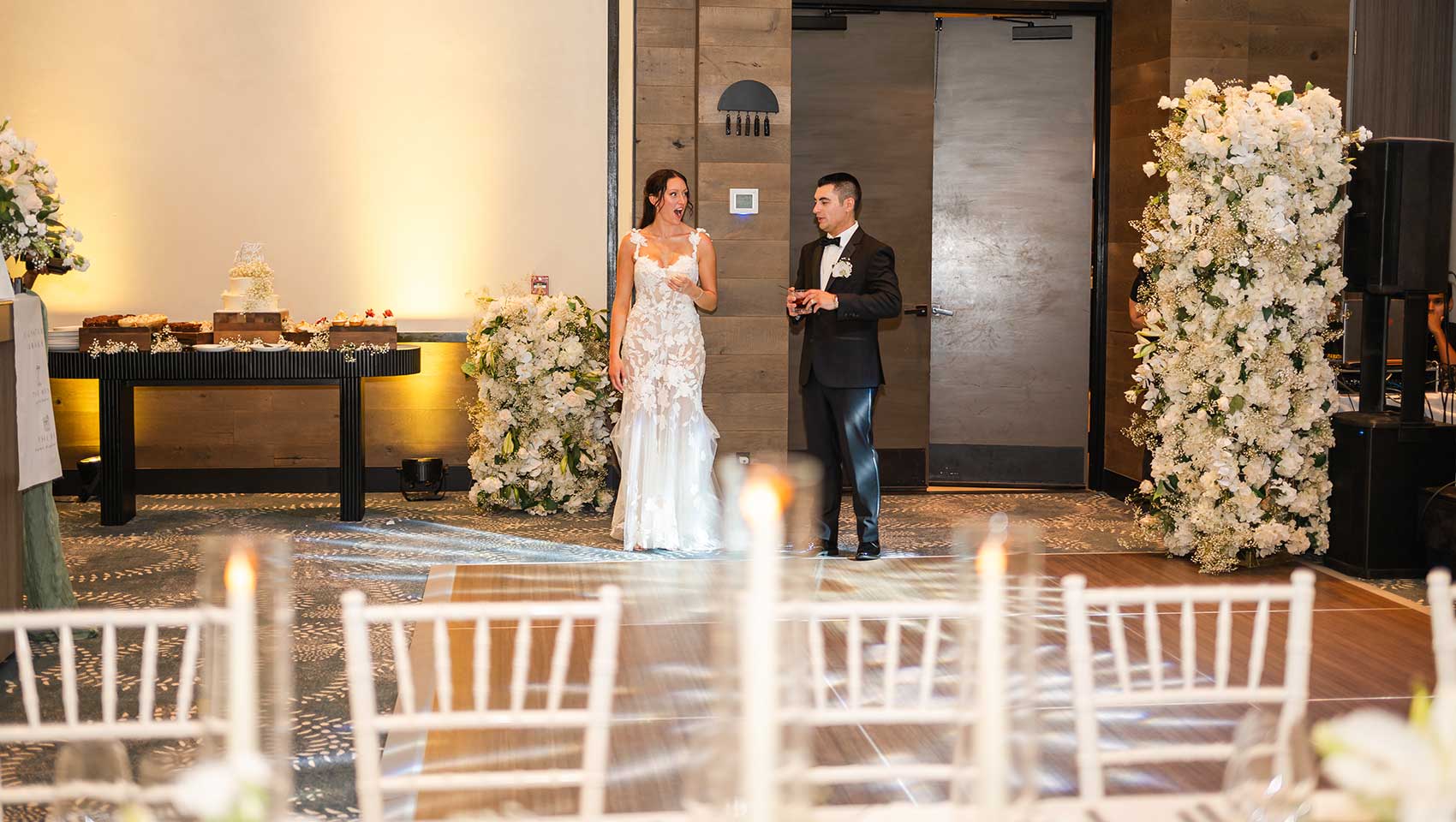 Bride and groom view indoor ceremony set-up at Kimpton Grand Roatan on Balcony