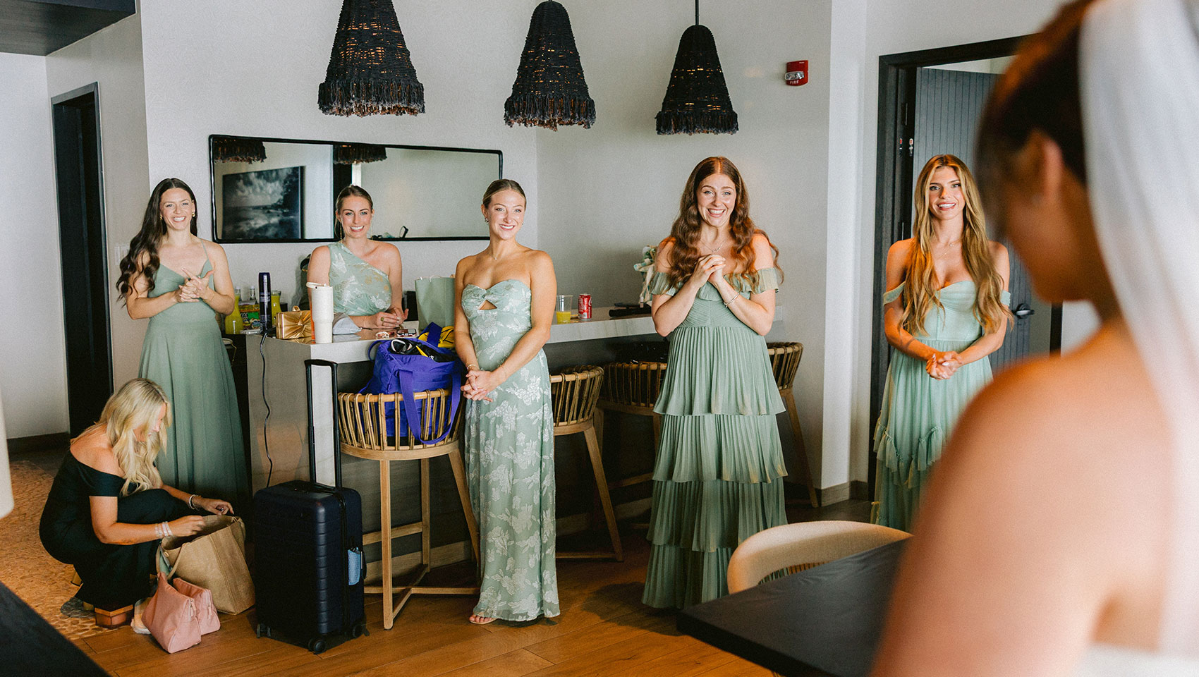 bridesmaids admiring bride in a suite at Kimpton Grand Roatan