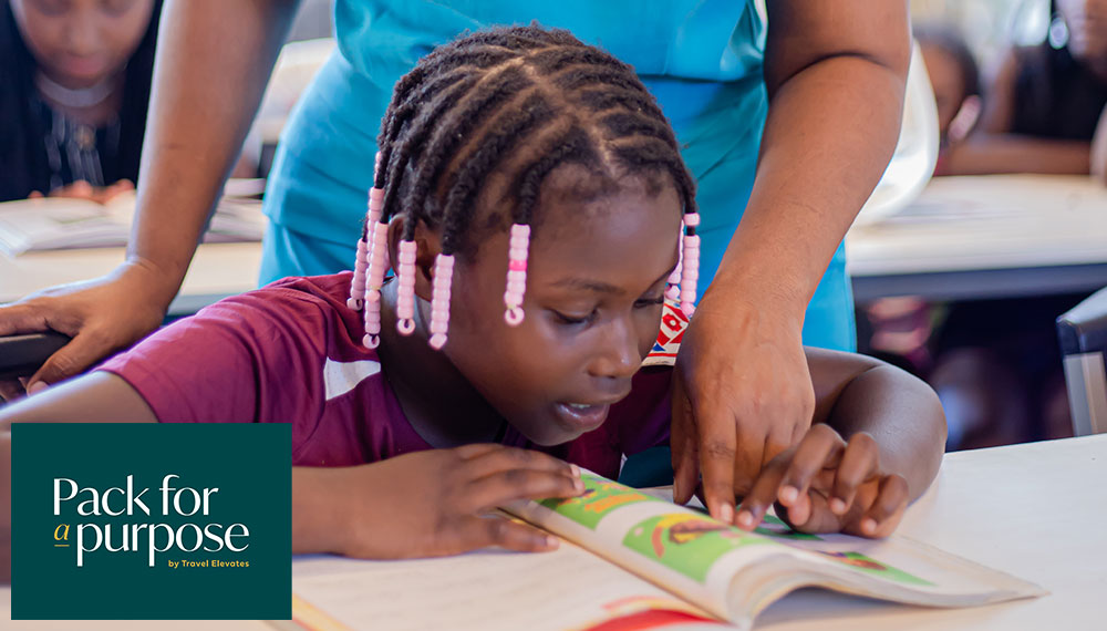 Woman assisting young girl with learning