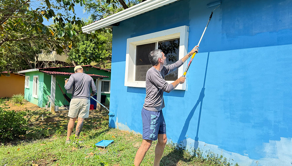 man painting house
