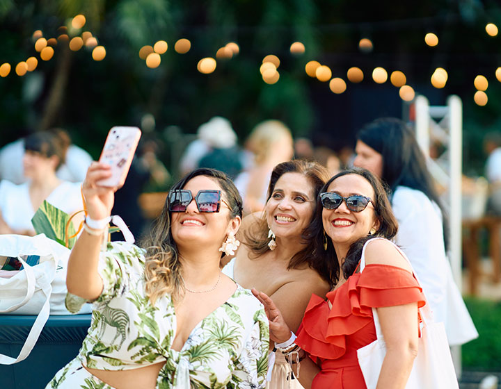 women taking a selfie at a wedding