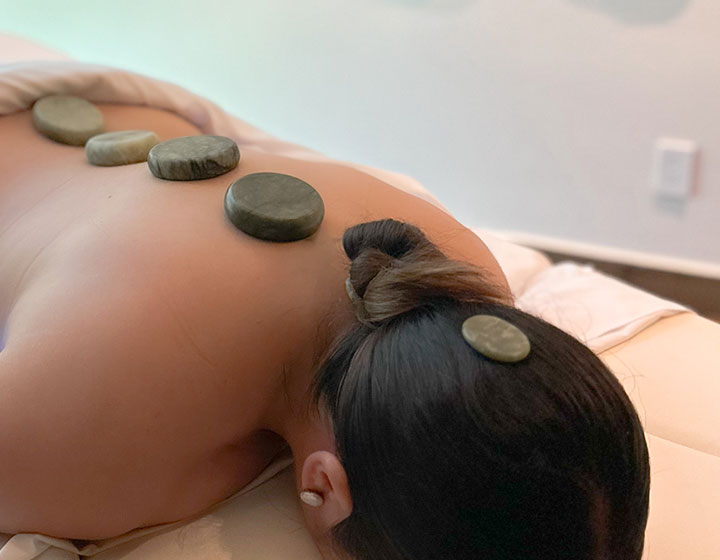 woman receiving hot stone massage