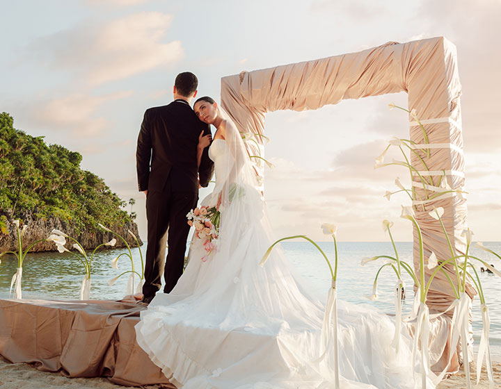 Briude and groom on custom ceremony set-up on the beach at Kimpton Grand Roatan
