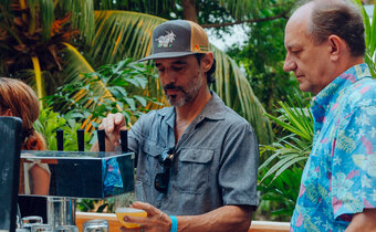 man waits for his beer to be poured from a tap at a beer station