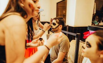 Man getting his face painted at Kimpton Grand Roatan