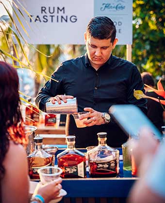 Man pouring rum cocktail at Kimpton Grand Roatan