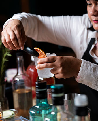 woman making a cocktail