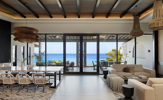 Four Bedroom Beachfront Penthouse living room and dining area with view of balcony