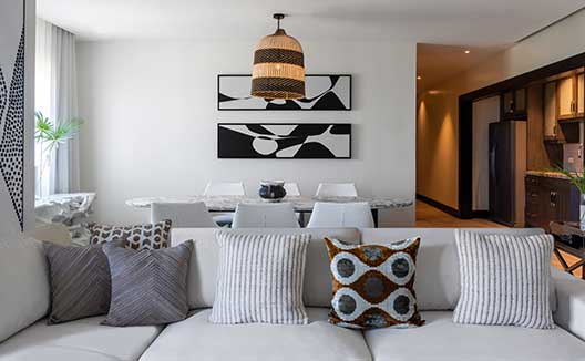 One Bedroom Premium Villa Suite Beachfront Couch & Dining Area