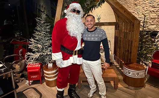 Kimpton Grand Roatan guest standing with Santa